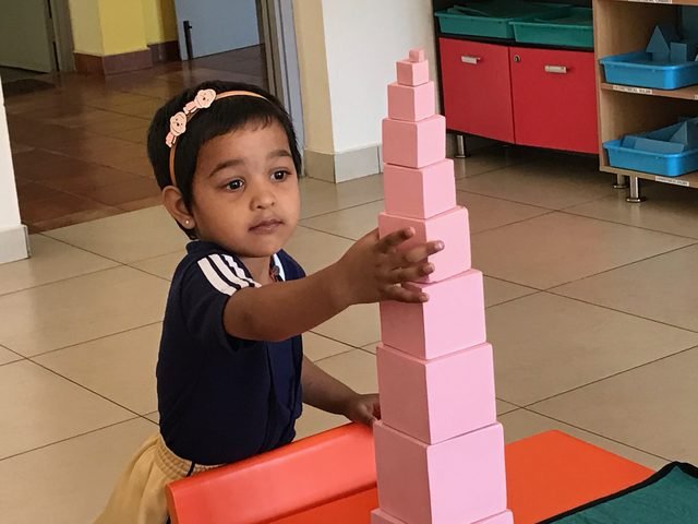 Child exploring with hands-on learning materials